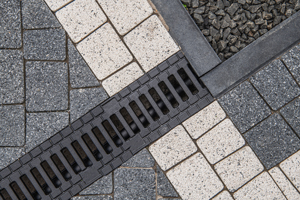 intersecting pavement tiles with a drainage grate featuring eight unique patterns and textures